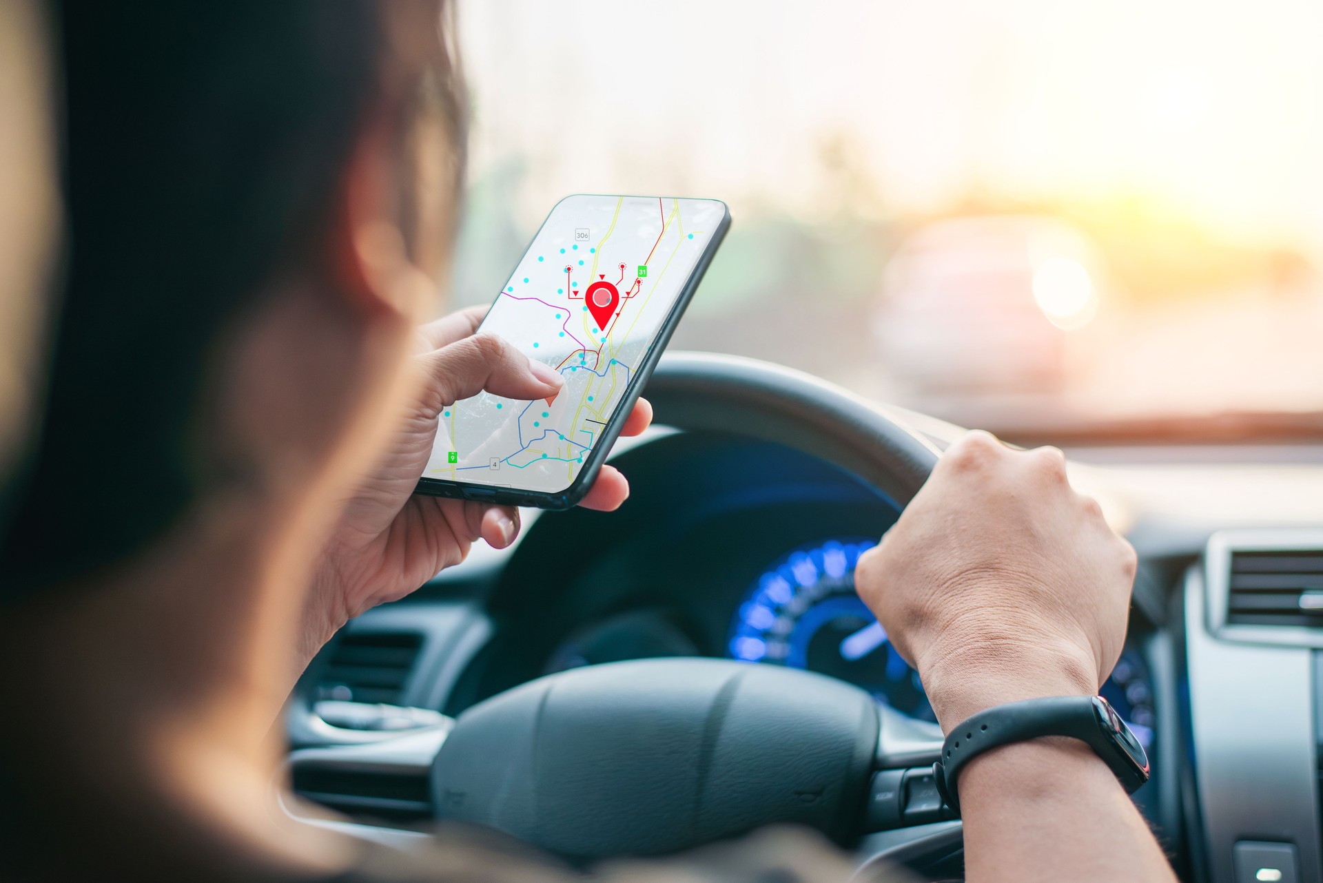 Driver using GPS navigation app on smartphone
