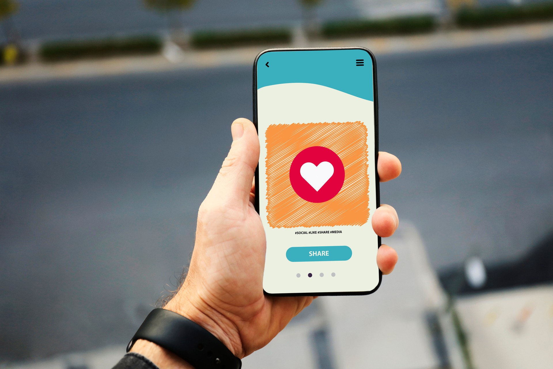 Hand holding smart phone with sending heart